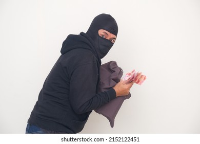 Bank Robber Wearing Black Balaclava And Hoodie For Disguise, Managed To Rob A Bank And Run Away With A Bag Full Of Money