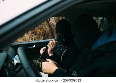 Bank Robbers With Their Masks On Pointing At The Map Prepared For Robbing The Bank,sitting In The Car And Waiting For The Right Time To Rob.