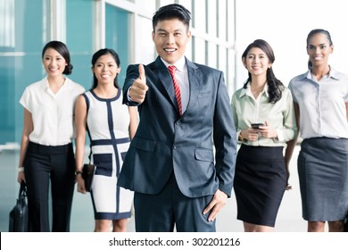 Bank Staff In Front Of Asian Office Showing Thumbs Up, Men And Women Of Chinese, Indonesian, And Indian Ethnicity