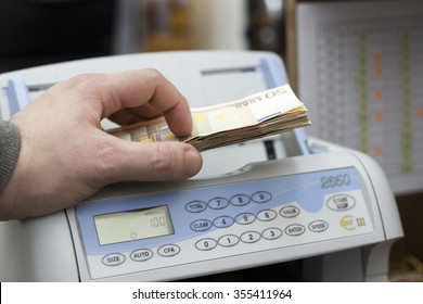 Bank Teller Counting Money In The Exchange Office