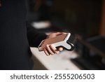 Bank terminal for contactless payment. Young man holds a terminal in his hands