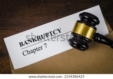 Bankcrupty Chapter 7 text on Document form and Wooden Gavel on office desk.