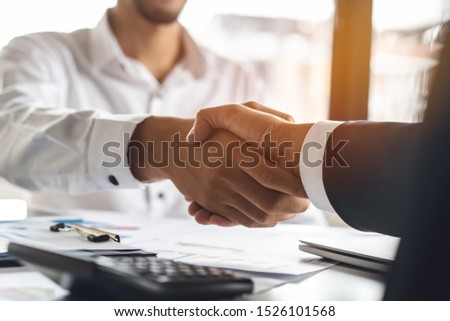 Banker and client shaking hands after business loan grant.