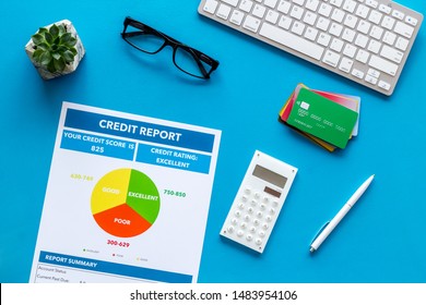 Banker Office Desk With Cards, Keyboard, Credit Report On Blue Background Top View