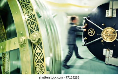 banker is opening safe door - Shutterstock ID 97135283