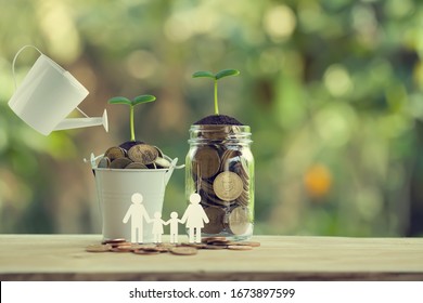 Banking and finance, Saving money concept: Water being poured on green sprout with glass bottle and bucket full of coins with family members. depicts investing money for earning growth.