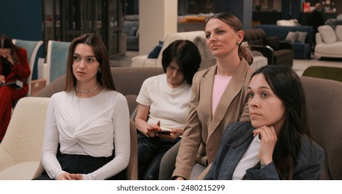 Banking seminar participants focus on financial strategies for success. Attentive group of women learning about banking industry trends and growth opportunities. Professional development insights. - Powered by Shutterstock