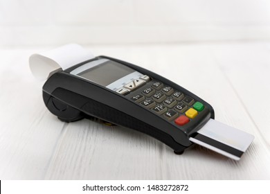 Banking terminal with credit card on wooden background