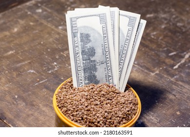 Banknotes in a bowl with buckwheat. The rise in food prices in Ukraine due to the war