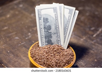 Banknotes in a bowl with buckwheat. The rise in food prices in Ukraine due to the war
