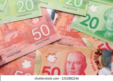 Banknotes Of Canadian Currency: Dollar. Canada Money. Full Frame Of Bills Spread On Table And Assorted Amounts.