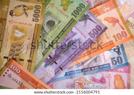 Banknotes of Democratic Socialist Republic of Sri Lanka background with selective focus. Different denomination.