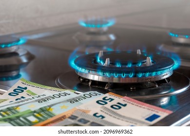 The Banknotes Lie Next To A Burning Gas Burner. The Concept Is To Increase The Cost Of Supply , Payment For Natural Gas. The Energy Crisis. High Cost, Price Of Gas.