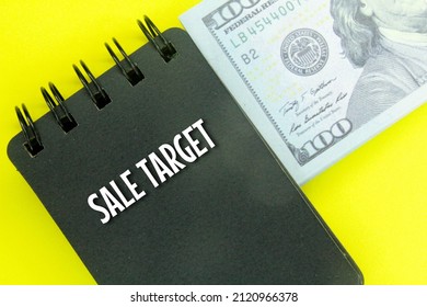 Banknotes And Notebooks With The Words Sale Target