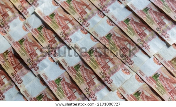 Banknotes of the Russian currency, an array of five\
thousand rubles with a close-up drawing. Scattered Russian ruble\
banknotes, money five thousand rubles. Scattered ruble banknotes,\
close-up view.