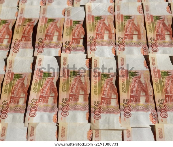 Banknotes of the Russian currency, an array of five\
thousand rubles with a close-up drawing. Scattered Russian ruble\
banknotes, money five thousand rubles. Scattered ruble banknotes,\
close-up view.