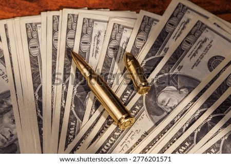Banknotes and weapon rounds on a dark wood table symbolize the dangerous world of criminal payoffs and the violent power of money in the underworld.!