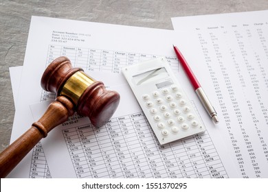 Bankruptcy concept. Judge hammer near financial documents on grey background