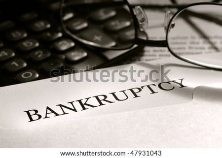 Bankruptcy filing legal notice letter with glasses and calculator (fictitious document with authentic legal language)
