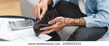 Bankruptcy problem financial concept, Young man opening empty wallet stress to find money to pay debt mortgage  period.