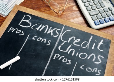 Banks Vs. Credit Unions Pros And Cons Written On A Blackboard.