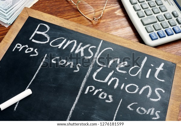 Banks vs. Credit Unions pros and cons written\
on a blackboard.