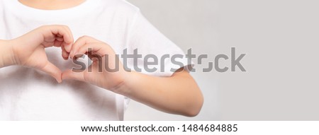 Banner of an adorable little child's hands gesture in heart shape showing love and kindness. Concept of Health care, Charity, Organ Donation, Generous, Pleasure, Hopeful, Love, World heart day.