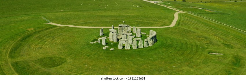 Banner - Aerial view of Stonehenge - sunny day in summer with no people around. This is a historic site with a ring of standing stones, it was believed to be a burial site. Blue sky and space for text