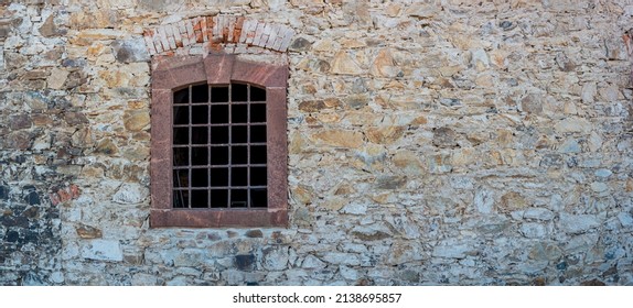 Banner with ancient stone wall and a metal grid window as a prison with copy space background. Concept of freedom and liberty