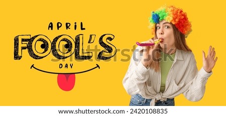 Banner for April Fools' Day with funny young woman wearing wig on yellow background