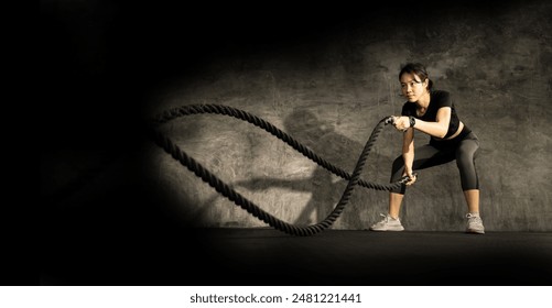 banner of  Asain Woman with battle rope battle ropes exercise in the fitness gym. gym, sport, rope, training, athlete, workout, exercises concept, copy space. - Powered by Shutterstock