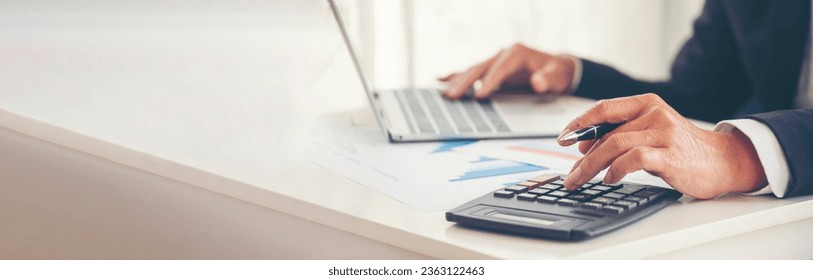 Banner Asian Business man hands using calculator counting tax financial bill. Tax audit Finacial concept. Panorama Close up businessman hands calculating number tax audit planning with copy space - Powered by Shutterstock