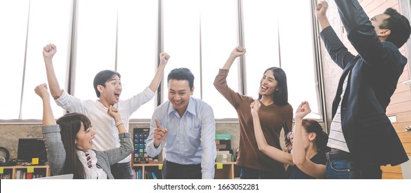 Banner Of Asian Creative Team Or Staff Employee Feeling Enjoy And Looking Together In Meeting Room At Modern Office. Brainstorming And Planning To Achieve Goal With Smart Work.