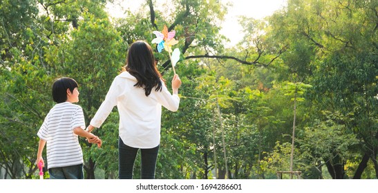 Banner Of Asian Mother Holding Son Hand Walking And Playing Together At Nature Park Outdoor Playground, Love And Support In Family, Healthy, Lifestyle And Living Insurance Concept With Copy Space