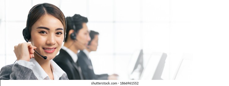 Banner Asian Team Call Center, Customer Service, Telesales In Casual With Headset Or Headphone And Look At Camera