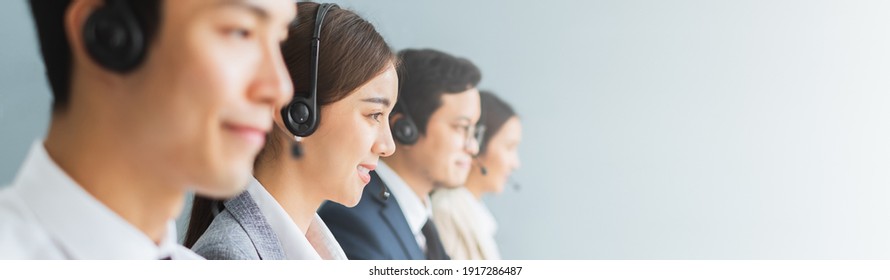 Banner Asian Team Call Center, Customer Service, Telesales In Casual With Headset Or Headphone And Look At Camera