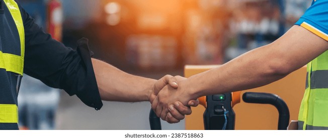 Banner Asian Teamwork Warehouse worker shakehand together. Engineer man, women handshake partnership. Coworker colleague logistics Warehouse teams. Team person shaking hand partner with copy space - Powered by Shutterstock