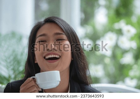 Banner of Asian woman Proprietor holding hot coffee in white ceramic cup to sniff smell of espresso in office work place . business owner entrepreneur girl carry coffee break to sniff fragrant smell