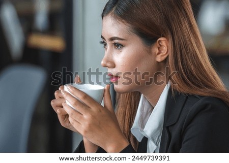 Banner of Asian woman Proprietor holding hot coffee in white ceramic cup to sniff smell of espresso in office work place . business owner entrepreneur girl carry coffee break to sniff fragrant smell