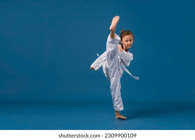 Banner: Asian-Australian girl poses in martial arts Practice taekwondo, karate, judo against a yellow background in the studio. Asian kids karate or Taekwondo martial arts. Sport kid training action. - Powered by Shutterstock