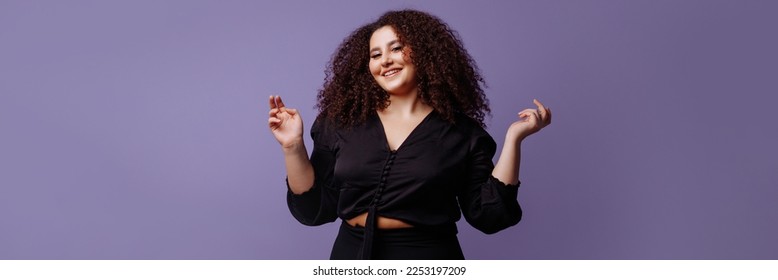 Banner attractive stylish plus size woman model with curly cool hairstyle in dark clothes on lilac background. - Shutterstock ID 2253197209