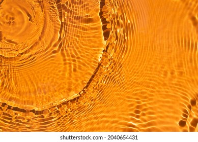 Banner or background for advertising cosmetics with orange water spills. Natural sunlight and shade. Beautiful bursts and glare. Summer mood. Minimal style.