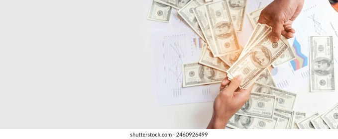 Banner Backside Businessman spreading 100 dollar banknote back jeans pocket. Hand holding money dollar bank note. Banner Man hands spread 100 dollar exchange cash with copy space. Bribe corruption - Powered by Shutterstock