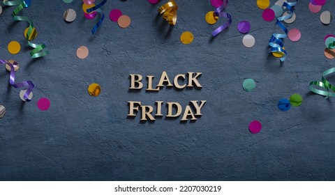 Banner With Black Friday Text And Holiday Tinsel Flat Lay On Dark Background