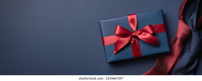 Banner with blue gift box and neckties on dark blue background. Father's day concept. - Shutterstock ID 2154467397