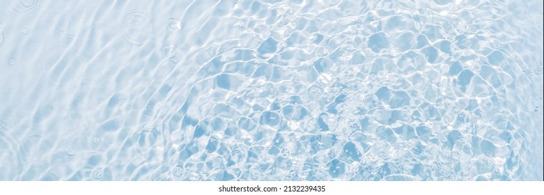 Banner of blue water, clean and transparent background, surface with vibrations from drops, flat lay