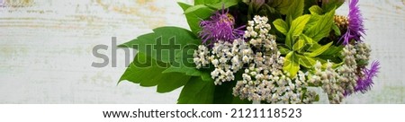 Banner with a bouquet of wild flowers on a wooden background. Rustic style. Copy space
