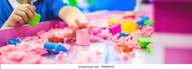 BANNER Boy Playing With Kinetic Sand In Preschool. The Development Of Fine Motor Concept. Creativity Game Concept. Long Format.