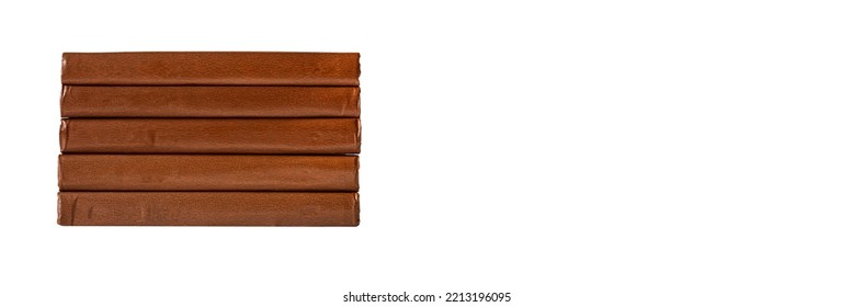 Banner With Brown Classic Books Stack With Emoty Spines In Leather Hardcover Isolated On White Background. High Quality Photo