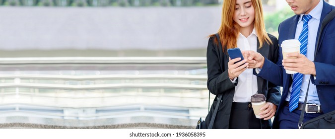 Banner Businessman Businesswoman Drinking Coffee In Town Using Smartphone Outside Office City. Panorama Hands Holding Take Away Coffee Cup, Smart Phone Talking Together Business Partner Copyspace